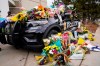 Police cruiser parked outside Boulder Police Department is covered with bouquets in tribute after an officer was one of the victims of a mass shooting at a King Soopers grocery store Tuesday, March 23, 2021, in Boulder, Colo. (AP Photo/David Zalubowski)