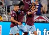 Colorado Rapids defender Lalas Abubakar, center, is congratulated on his goal by forward Andre Shinyashiki, left, and midfielder Cole Bassett during the second half of the team's MLS soccer match against FC Dallas on Wednesday, July 21, 2021, in Commerce City, Colo. The Rapids won 2-0. (AP Photo/David Zalubowski)