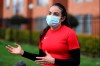 Wearing a face mask, Venezuelan soccer player María Alejandra Peraza, who played last season with Colombia's Millonarios women's team, speaks during an interview in Bogota, Colombia, Thursday, May 21, 2020. Peraza is one of hundreds of professional female players who have received a food package from the Ministry of Sport in Colombia during the lockdown to curb the COVID-19. (AP Photo/Fernando Vergara)