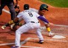 Oakland Athletics' Tony Kemp (5) avoids the tag at home plate by Colorado Rockies third baseman Josh Fuentes (8) during the third inning of a baseball game, Wednesday, Sept. 16, 2020, in Denver. (AP Photo/Jack Dempsey)