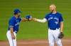 Third base coach Luis Rivera, left, returns Travis Shaw’s hat during MLB intrasquad baseball action in Toronto on Friday, July 10, 2020. THE CANADIAN PRESS/Carlos Osorio