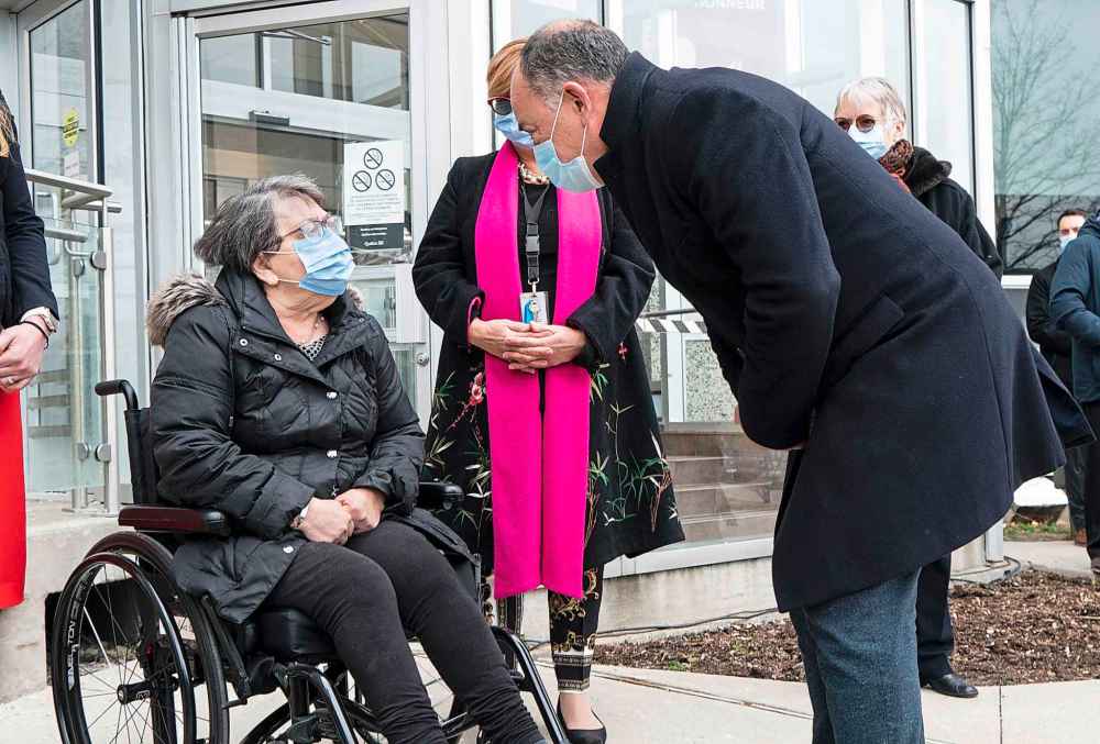 Quebec Health Minister Christian Dube greets Maimonides CHSLD resident Gloria Lallouz after she received a first dose of COVID-19 vaccine in Montreal, on Monday, December 14, 2020. THE CANADIAN PRESS/Paul Chiasson