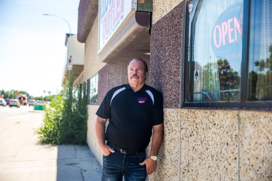 MIKAELA MACKENZIE / WINNIPEG FREE PRESSRobert McDonald in front of his store, Surplus Direct Clothing Outlet, is concerned about cars lined up in front of his business waiting for the nearby drive through COVID-19 testing site.