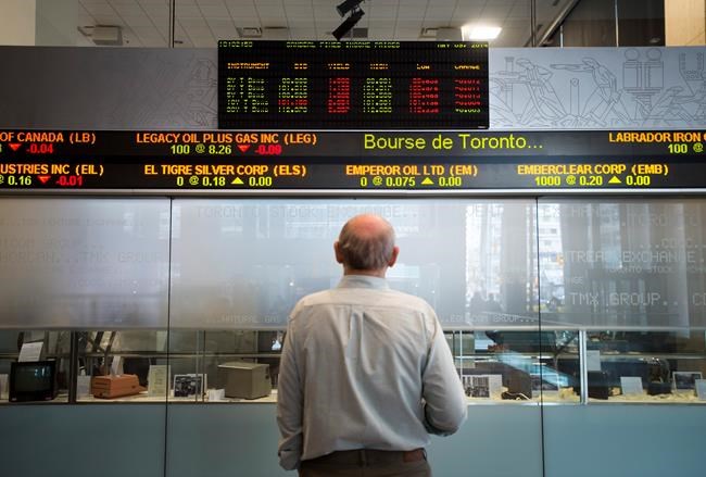 A man watches the financial numbers at the TMX Group in Toronto's financial district in a May 9, 2014 photo. THE CANADIAN PRESS/Darren Calabrese
