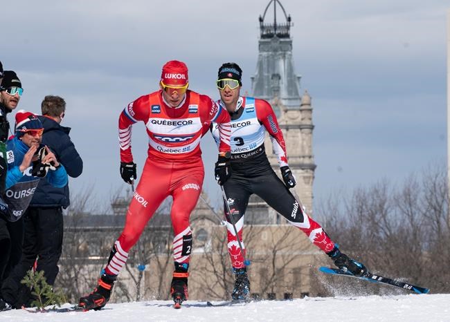 Alexander Bolshunov of Russia, left, and Alex Harvey of St-Ferreol-les-Neiges Que. race during the men's 15 km pursuit free Sunday, March 24, 2019 at the COOP FIS cross country world cup in Quebec City. The World Cup cross-country ski event this weekend in Quebec City has been cancelled because of the COVID-19 outbreak. THE CANADIAN PRESS/Jacques Boissinot