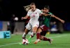 Kaila Novak of Canada, left, fights for the ball with Ximena Rios of Mexico during a 2018 FIFA U-17 Women's World Cup semifinal soccer match in Montevideo, Uruguay, Wednesday, Nov. 28, 2018. Second-half goals by captain Tanya Boychuk and Novak lifted Canada to a 2-0 win over El Salvador in its opening match Saturday at the CONCACAF Women's Under-20 Championship. THE CANADIAN PRESS/AP/Matilde Campodonico