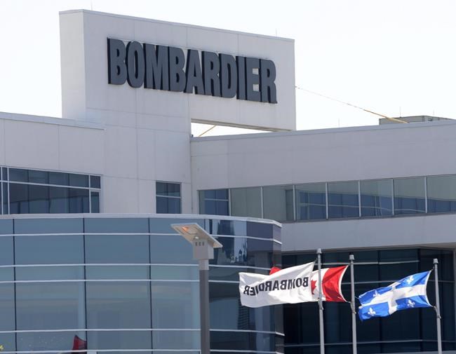 Flags fly outside a Bombardier plant in Montreal, on May 14, 2015. THE CANADIAN PRESS/Ryan Remiorz
