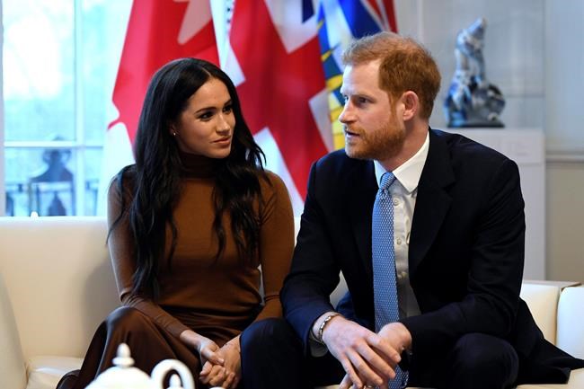 Britain's Prince Harry and Meghan, Duchess of Sussex gesture during their visit to Canada House in thanks for the warm Canadian hospitality and support they received during their recent stay in Canada, in London, Tuesday, Jan. 7, 2020. The NDP's Canadian Heritage critic says he believes Prince Harry and his family should pay for their own security costs while they're in Canada. THE CANADIAN PRESS/AP, Daniel Leal-Olivas/Pool Photo