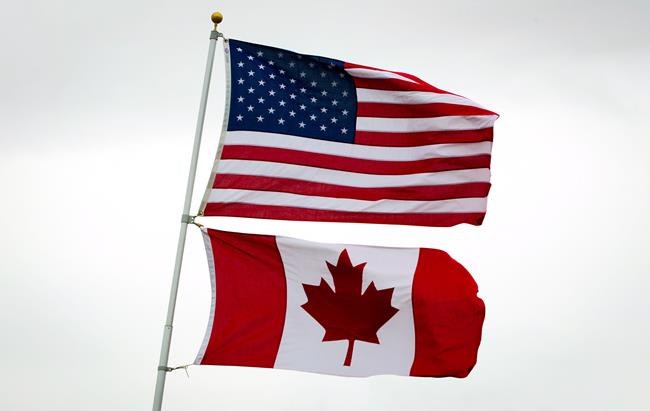 U.S. and Canadian flags fly in Point Roberts, Wash., on Tuesday March 13, 2012. President Donald Trump is confirming that the Canada-U.S. border will be closed