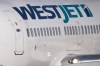 A pilot taxis a Westjet Boeing 737-700 plane to a gate after arriving at Vancouver International Airport in Richmond, B.C., on Monday February 3, 2014. A WestJet flight from Toronto to Jamaica had to turn back Monday after the airline says a passenger made an 