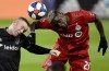 D.C. United forward Wayne Rooney (9) and Toronto FC defender Chris Mavinga (23) vie for a header during first half MLS playoff soccer action in Toronto on Saturday, Oct. 19, 2019. Toronto FC nailed down a key part of its defence Thursday, signing centre back Mavinga to a contract extension.THE CANADIAN PRESS/Frank Gunn