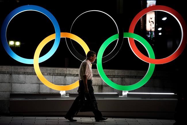 A man walks past the Olympic rings Tuesday, July 23, 2019, in Tokyo, as Japan marks a year-to-go until hosting the summer games with Olympic medals being unveiled Wednesday as part of daylong ceremonies around the Japanese capital. The Canadian Olympic Committee released its marketing guidelines Tuesday for athletes and their personal sponsors during the 2020 Olympics in Tokyo from July 24 through Aug. 9. THE CANADIAN PRESS/AP/Jae C. Hong