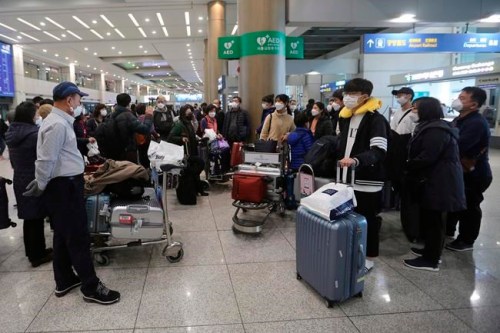 South Koreans tourists gather after returning from Israel at Incheon International Airport in Incheon, South Korea, Tuesday, Feb. 25, 2020. South Korean tourists returned home from Israel on Tuesday after the Israeli government imposed entry ban on South Koreans over concerns about new coronavirus. THE CANADIAN PRESS/AP, Ahn Young-joon