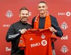 Rocco Romeo and coach Greg Vanney hold up a Toronto FC jersey at the team's training facility in Toronto, Monday, Jan.20, 2020. The MLS club has signed the defender to a contract as a homegrown player.THE CANADIAN PRESS/HO-Toronto FC MANDATORY CREDIT