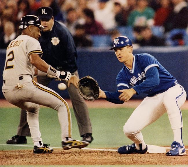 Toronto Blue Jays first baseman John Olerud waits for the ball as Pittsburgh Pirates Gary Redus goes back to first during exhibition action in Toronto on March 13, 1992. Former Toronto Blue Jays first baseman and two-time World Series champion John Olerud headlines the four-man class that will be inducted into the Canadian Baseball Hall of Fame this summer. THE CANADIAN PRESS/Scott MacDonald