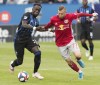 Montreal Impact's Bacary Sagna, left, challenges New York Red Bulls' Daniel Royer during second half MLS soccer action in Montreal, Sunday, Oct. 6, 2019. Veteran French international defender Sagna has said goodbye to the Montreal Impact. THE CANADIAN PRESS/Graham Hughes