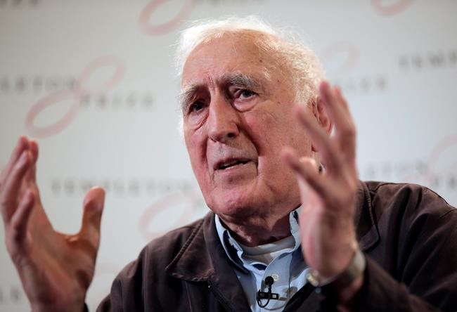 Jean Vanier, the founder of L'ARCHE, gestures as he talks during a news conference, in central London, Wednesday, March 11, 2015. Canadian schools and organizations associated with the late Jean Vanier are facing difficult decisions in the wake of a report that found the once-revered figure sexually abused at least six women.THE CANADIAN PRESS/AP, Lefteris Pitarakis