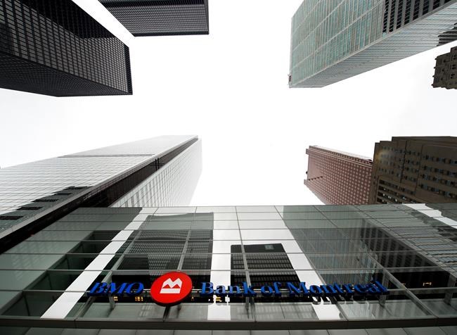 A Bank of Montreal sign is shown in the financial district in Toronto on August 22, 2017. The Bank of Montreal says it is separating some of its critical trading staff to protect itself against an outbreak of a novel form of coronavirus. BMO spokesperson Julie Smithers says in a statement to The Canadian Press that the policy impacts the bank's operations in Canada, the U.S., London and Asia. THE CANADIAN PRESS/Nathan Denette