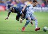 Vancouver Whitecaps' Cristian Dajome, left, collides with Sporting Kansas City's Luis Martins during the second half of an MLS soccer game in Vancouver, B.C., Saturday, Feb. 29, 2020. Major League Soccer has extended its season hiatus for the next eight weeks, with a target return date of May 10. THE CANADIAN PRESS/Darryl Dyck