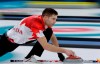 Canada's John Morris throws a stone during the mixed doubles final curling match against Switzerland Jenny Perret and Martin Rios at the 2018 Winter Olympics in Gangneung, South Korea, Tuesday, Feb. 13, 2018. Decorated Canadian curler John Morris returns to team curling after a hiatus and joins a powerhouse foursome skipped by Kevin Koe. Morris, 41, reunites with lead Ben Hebert, with whom he won an Olympic gold medal and world championship. THE CANADIAN PRESS/AP, Natacha Pisarenko