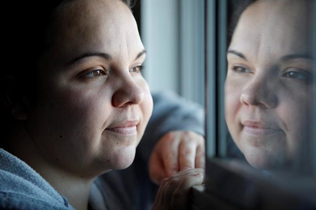 Jessica Reid poses in her Winnipeg apartment Friday, December 20, 2012. Charges have been stayed for a woman who testified that she was tortured, beat and burned in the months leading up to another woman's body being found in a barrel. THE CANADIAN PRESS/John Woods