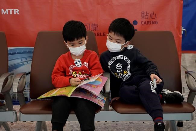 Passengers wear masks to prevent an outbreak of a new coronavirus in the high speed train station, in Hong Kong, Wednesday, Jan. 22, 2020. THE CANADIAN PRESS/AP/Kin Cheung