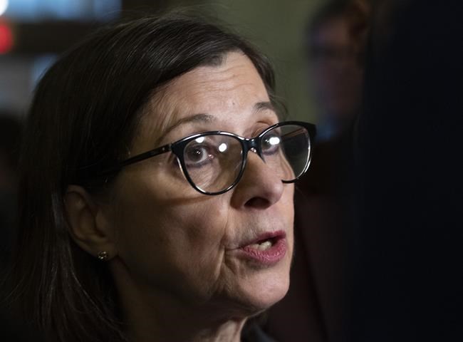 Quebec Health Minister Danielle McCann responds to reporters questions before entering a government caucus meeting Tuesday, February 18, 2020 at the legislature in Quebec City. Quebec public health officials are reporting the province's first presumptive case of the new coronavirus, dubbed COVID-19. THE CANADIAN PRESS/Jacques Boissinot