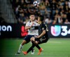 Vancouver Whitecaps defender Jake Nerwinski, left, vies for the ball with Los Angeles FC midfielder Eduard Atuesta during the second half of a Major League Soccer game in Los Angeles on July 6, 2019. The Vancouver Whitecaps are hoping that young legs will lead to improved results as their 10th season in Major League Soccer kicks off on Saturday night. Vancouver finished 23rd overall in the 24-team league last season with a 8-16-10 record. A raft of off-season changes has the Whitecaps entering the new year with an average age of 24.1, the youngest team in MLS. 