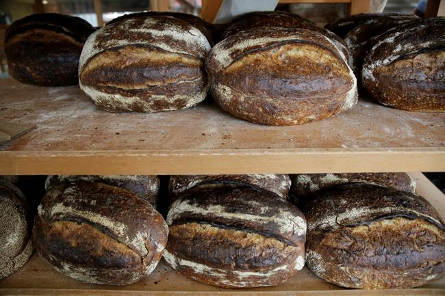 Freshly baked loaves of bread on a rack at the Tartine Manufactory in San Francisco on Friday, Aug. 11, 2017. The time-honoured tradition of baking has become a welcome respite from the stressors of the outside world. THE CANADIAN PRESS/AP, Eric Risberg
