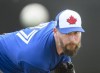 Toronto Blue Jays pitcher John Axford throws a bullpen session during baseball spring training in Dunedin, Fla., on Wednesday, February 20, 2019. Axford is taking a break from wondering about his baseball future. THE CANADIAN PRESS/Nathan Denette