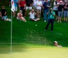 FILE - In this June 22, 2018, file photo, Rory McIlroy hits out of a bunker on the 18th hole during the second round of the Travelers Championship golf tournament at TPC River Highlands in Cromwell, Conn. The tournament director for this week's Travelers Championship thought about encircling the 18th green at TPC River Highlands with giant video boards that could be filled with images of fans watching the golf and cheering from home. Thursday's, June 25, 2020, tournament will be held without fans, but is still expected to raise significant funds for charity. (Patrick Raycraft/Hartford Courant via AP, File)