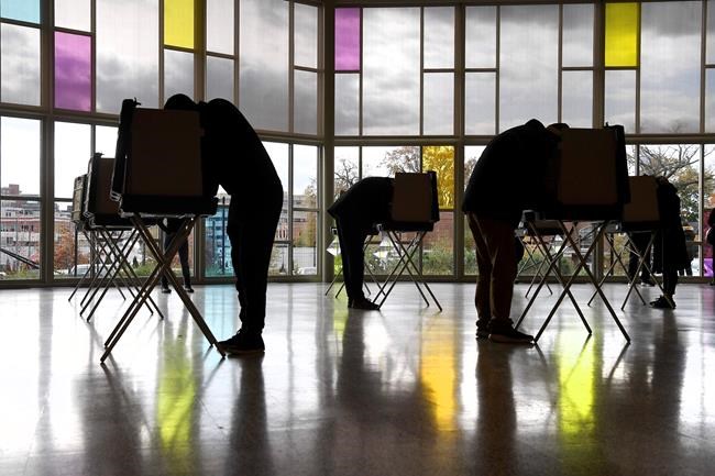 Voters mark their ballots at First Presbyterian Church on Election Day, Tuesday, Nov. 3, 2020, in Stamford, Conn. (AP Photo/Jessica Hill)