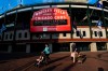 People wear face masks and walk outside of Wrigley Field before a baseball game between the Chicago Cubs and the Minnesota Twins, Sunday, Sept. 20, 2020, in Chicago. It will be the last home game of the season. (AP Photo/Matt Marton)