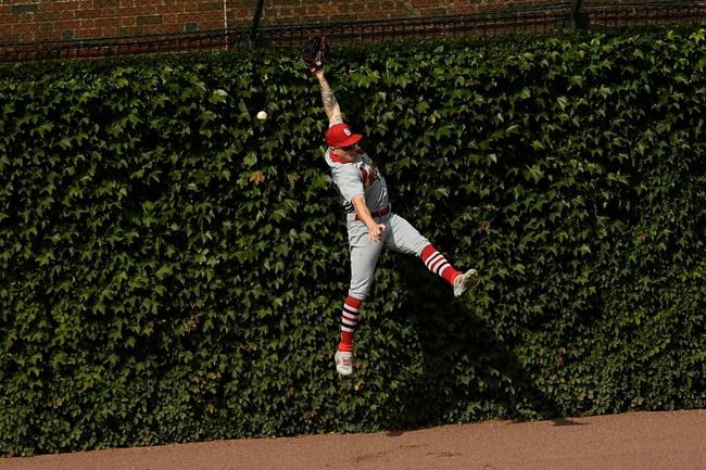 St. Louis Cardinals left fielder Tyler O'Neill misses a double by Chicago Cubs' Ian Happ during the first inning of a baseball game Monday, Sept. 7, 2020, in Chicago. (AP Photo/Paul Beaty)