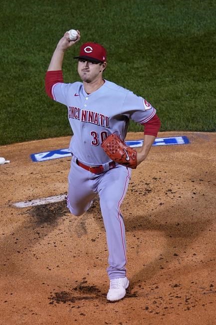 Cincinnati Reds starting pitcher Tyler Mahle delivers during the first inning of a baseball game against the Chicago Cubs Tuesday, Sept. 8, 2020, in Chicago. (AP Photo/Charles Rex Arbogast)