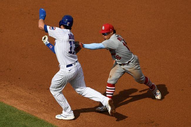 St. Louis Cardinals second baseman Kolten Wong, right, tags out Chicago Cubs' Kris Bryant between first base and second base during the second inning of a baseball game Monday, Sept. 7, 2020, in Chicago. (AP Photo/Paul Beaty)