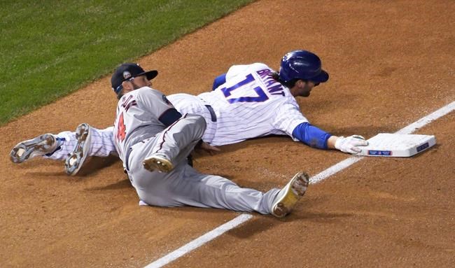 Minnesota Twins third baseman Josh Donaldson (24) tags out Chicago Cubs' Kris Bryant (17) at third base during the first inning of a baseball game, Friday, Sept. 18, 2020, in Chicago. (AP Photo/David Banks)