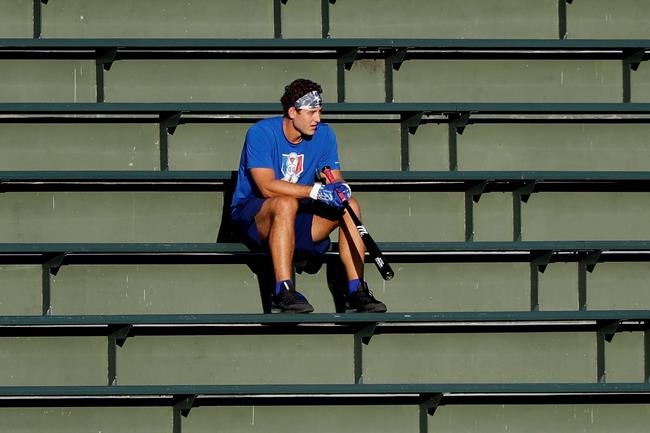 Chicago Cubs infielder Anthony Rizzo watches teammates during baseball practice at Wrigley Field in Chicago, Friday, July 10, 2020. (AP Photo/Nam Y. Huh)