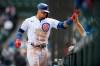 Chicago Cubs' Javier Baez celebrates at the dugout with manager David Ross after hitting a solo home run during the second inning of a baseball game against the Milwaukee Brewers, Friday, April 23, 2021, in Chicago. (AP Photo/Paul Beaty)