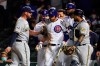 Chicago Cubs' Willson Contreras, center is restrained by Milwaukee Brewers first baseman Travis Shaw, left, and catcher Omar Narvaez, right, after being hit by a pitch as benches cleared during the ninth inning of a baseball game, Tuesday, April 6, 2021, in Chicago. (AP Photo/David Banks)