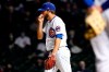 Chicago Cubs relief pitcher Ryan Tepera blows on his throwing hand during the sixth inning of a baseball game against the Atlanta Braves in Chicago, Sunday, April 18, 2021. (AP Photo/Nam Y. Huh)