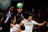 PSG's Layvin Kurzawa, center, jumps for the ball during the French League One soccer match between Paris-Saint-Germain and Montpellier at the Parc des Princes stadium in Paris, Saturday Feb. 1, 2020. (AP Photo/Christophe Ena)