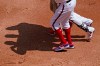 Chicago White Sox's Luis Robert, center, leaves with a team trainer and first base coach Daryl Boston during the first inning of a baseball game against the Cleveland Indians in Chicago, Sunday, May 2, 2021. (AP Photo/Nam Y. Huh)