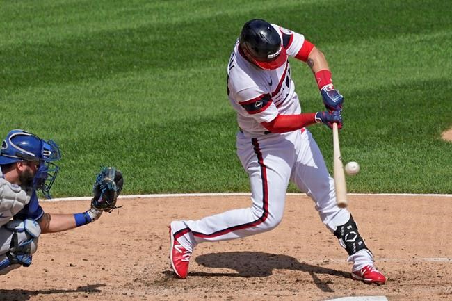 Chicago White Sox's Yasmani Grandal hits a single against the Kansas City Royals during the third inning of a baseball game in Chicago, Sunday, Aug. 30, 2020. (AP Photo/Nam Y. Huh)