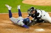 Chicago White Sox catcher Yasmani Grandal tags Texas Rangers' Willie Calhoun out at home off the throw by Billy Hamilton during the seventh inning of a baseball game Saturday, April 24, 2021, in Chicago. (AP Photo/Charles Rex Arbogast)