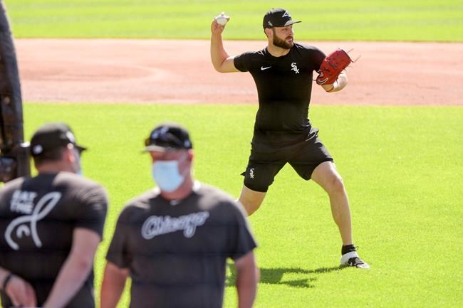 Chicago White Sox pitcher Lucas Giolito sets up to throw the ball to first base during practice at Guaranteed Rate Field on Sunday, July 5, 2020, in Chicago. (AP Photo/Mark Black)