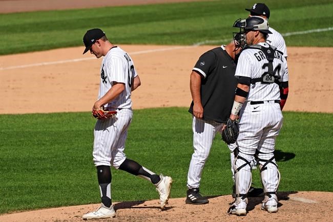 Chicago White Sox relief pitcher Zack Burdi, left, leaves the field after he was relieved by manager Rick Renteria during the seventh inning of a baseball game against the Kansas City Royals in Chicago, Saturday, Aug. 29, 2020. (AP Photo/Nam Y. Huh)