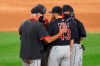 Cleveland Indians pitching coach Carl Willis, left, talks with starting pitcher Aaron Civale during the seventh inning of a baseball game against the Chicago White Sox Friday, Aug. 7, 2020, in Chicago. (AP Photo/Charles Rex Arbogast)