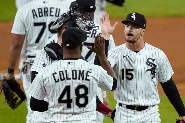 Chicago White Sox's Adam Engel (15) celebrates with catcher Yasmani Grandal and relief pitcher Alex Colome the team's 3-1 win over the Minnesota Twins after a baseball game, Monday, Sept. 14, 2020, in Chicago. (AP Photo/Charles Rex Arbogast)