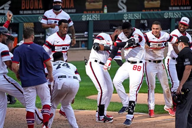 Chicago White Sox's Luis Robert (88) celebrates with teammates after hitting a winning three-run home run against the Kansas City Royals during the 10th inning of a baseball game in Chicago, Sunday, Aug. 30, 2020. (AP Photo/Nam Y. Huh)